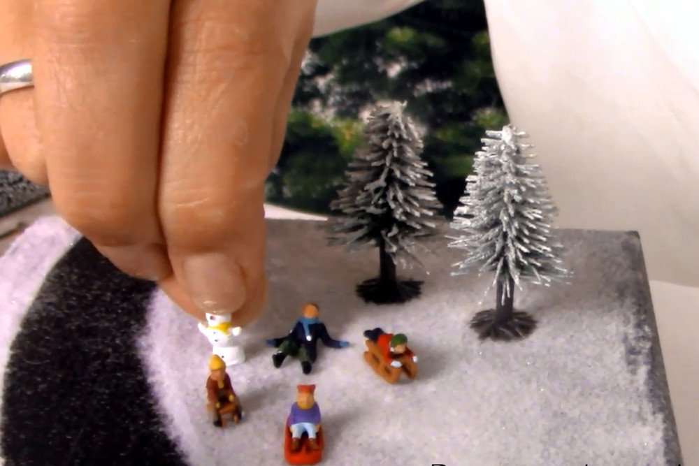 4) Decorate with figures and snow firs 