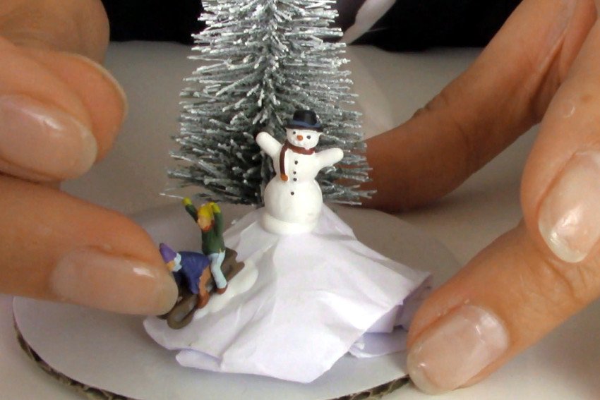 3. Decorate mini landscapes with a snowy hill and figures